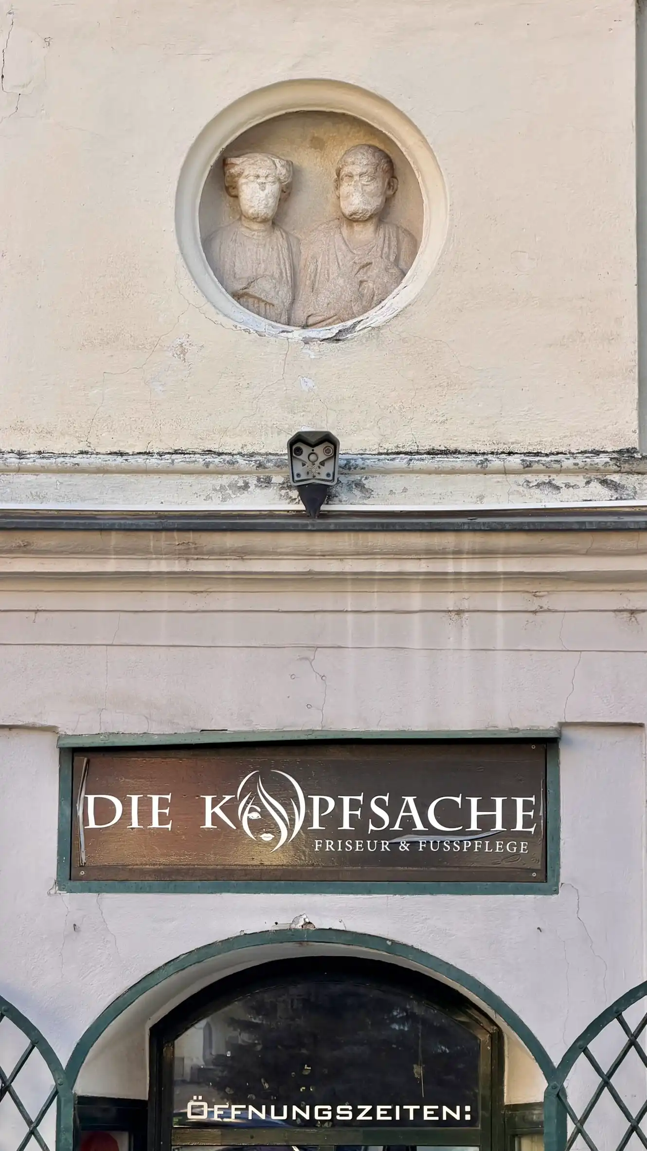 Roman funerary medallion above a round-arched portal