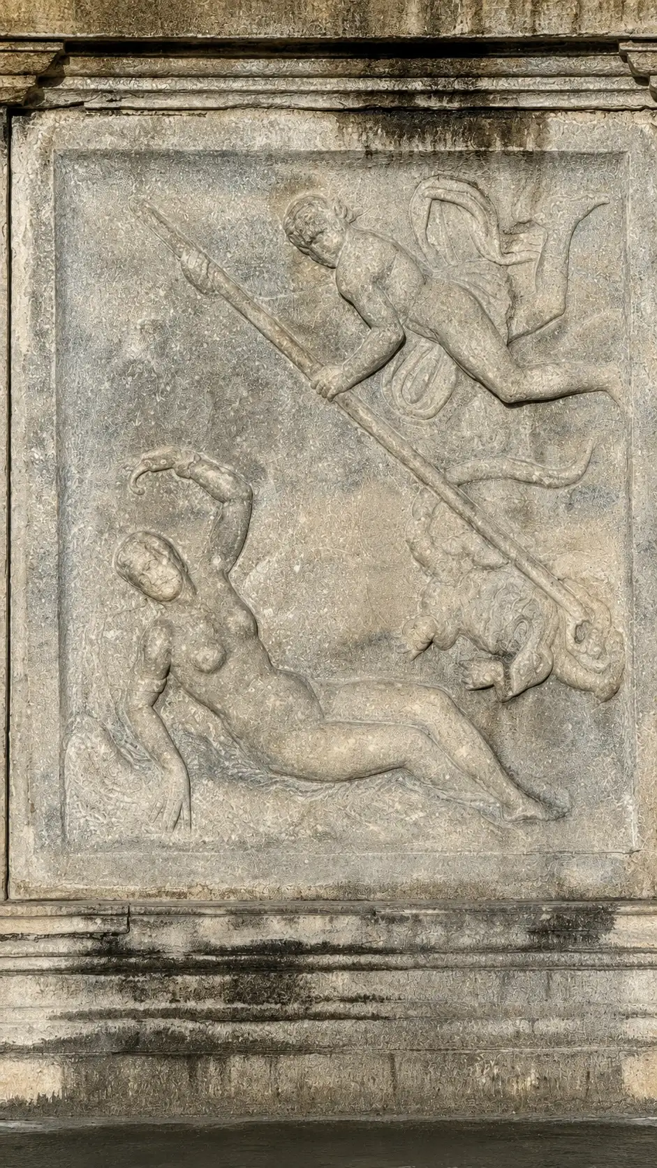 Perseus fights a monster and frees the chained Andromeda.